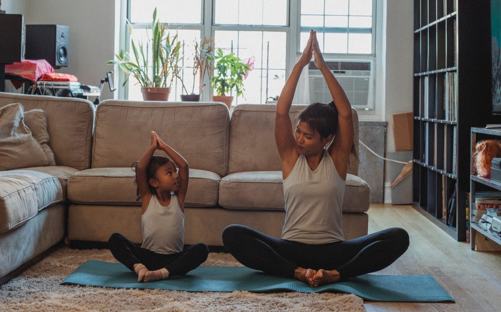 woman and daughter practicing yoga