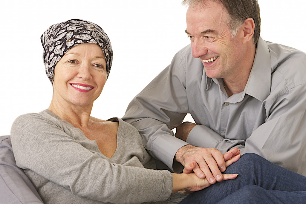 husband supportive attitude after wife' s chemotherapy - woman wearing protective headscarf
