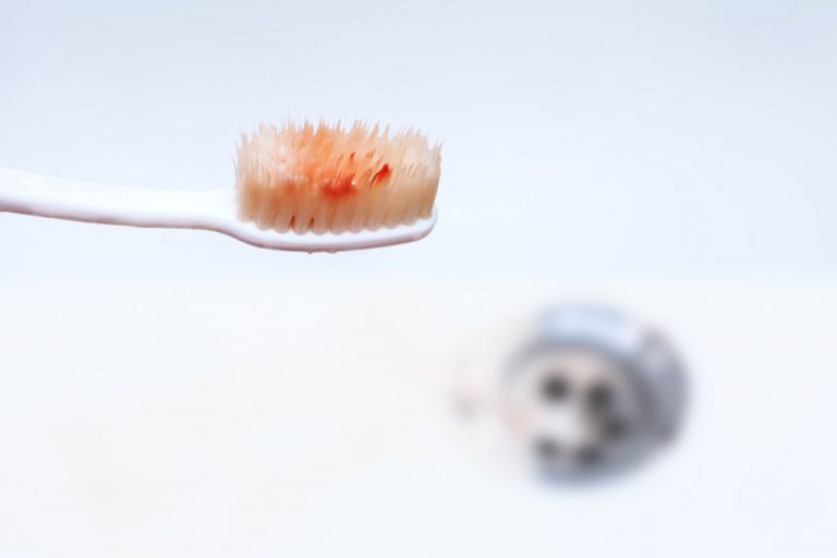 Image of blood on a toothbrush by the sink