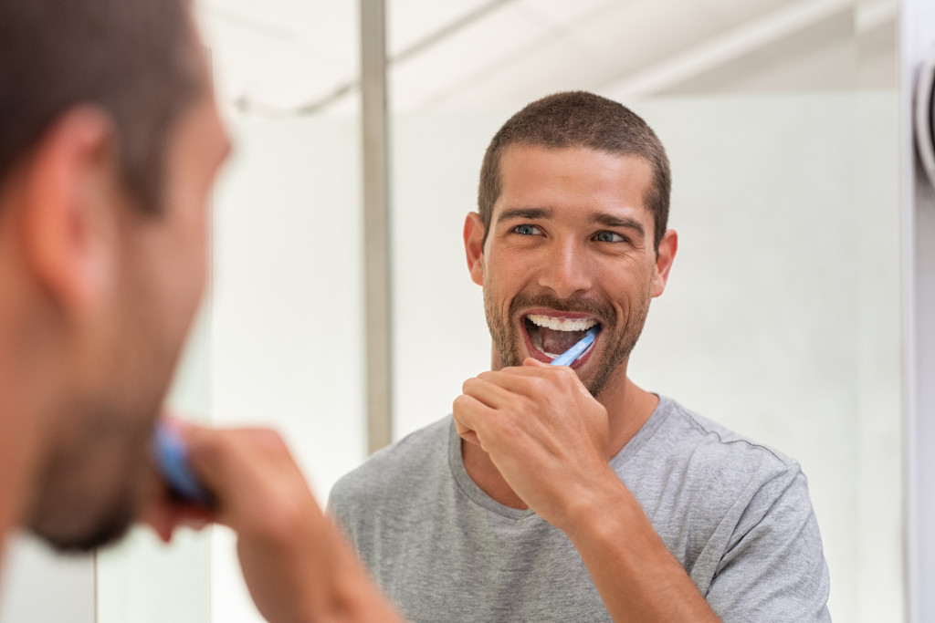 a man using a toothbrush