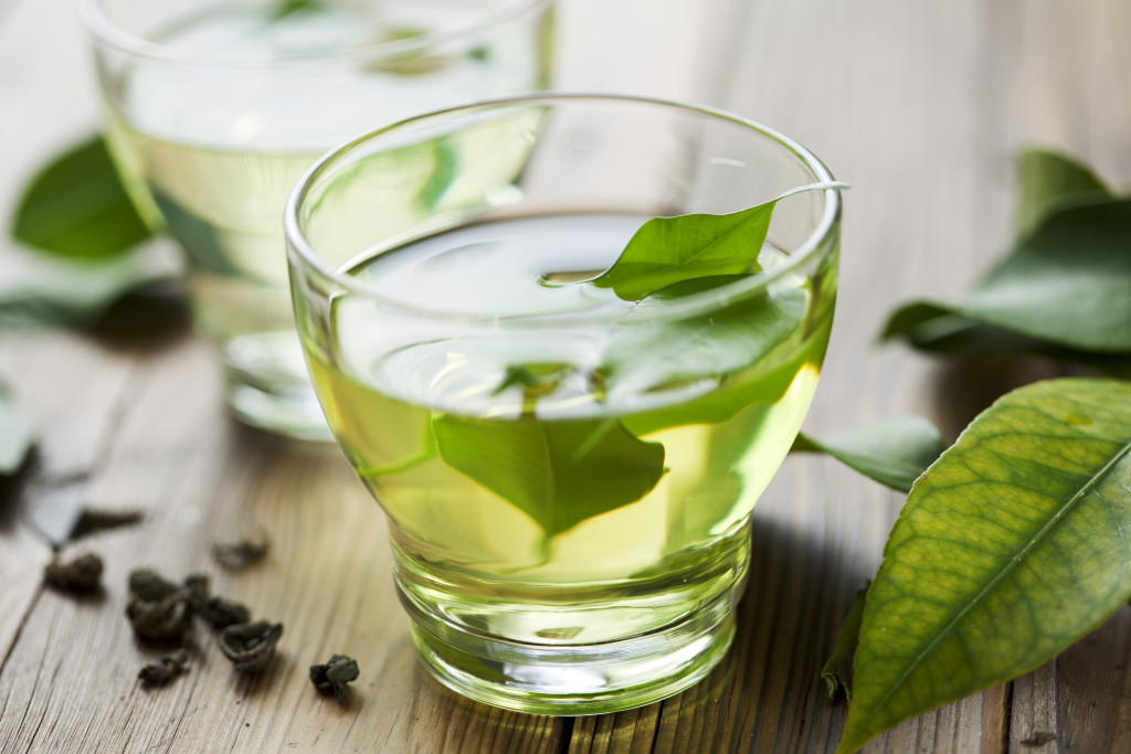 green tea with leaves in cup