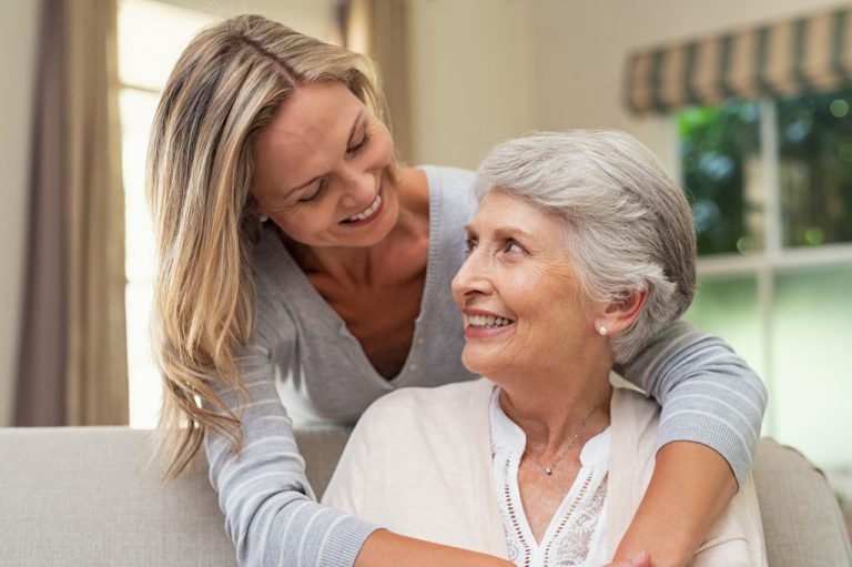 adult woman taking care of her old mother