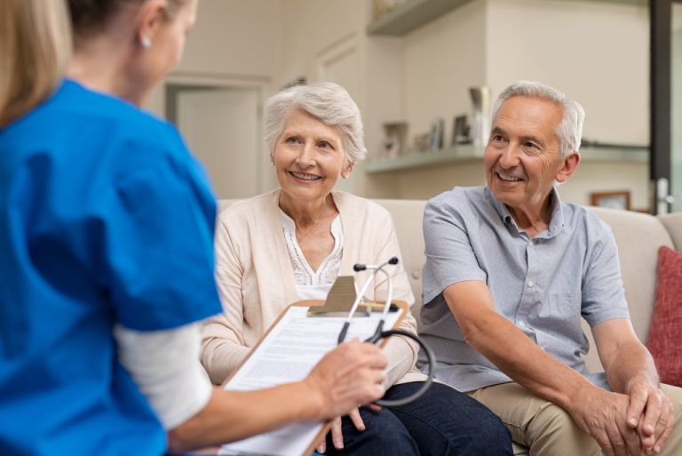 health professional talking to two old patients