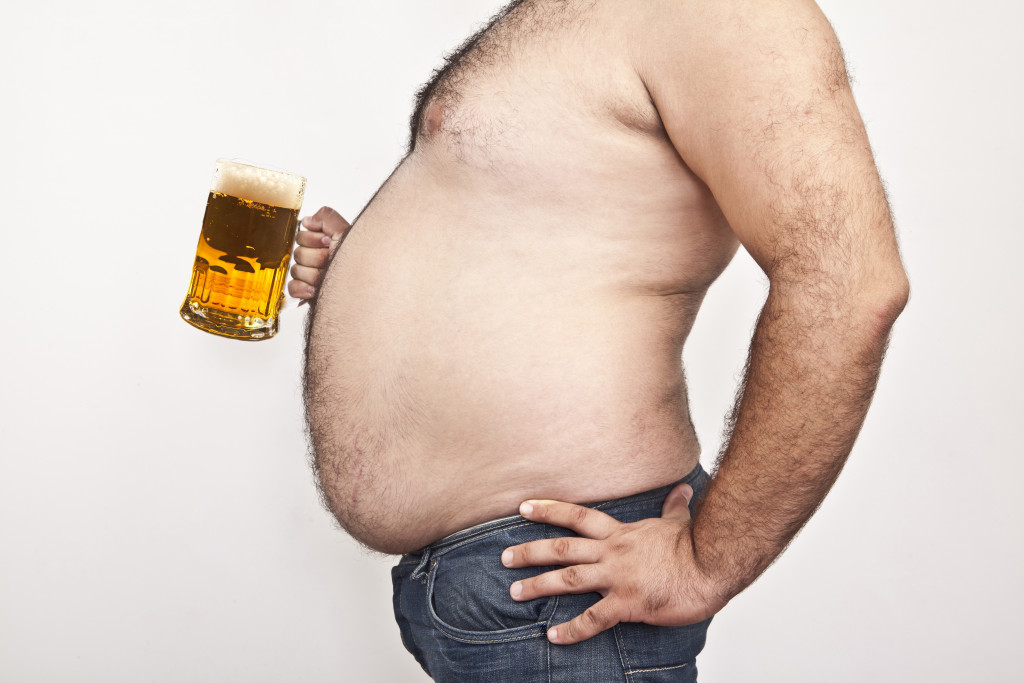 Obese man with beer mug