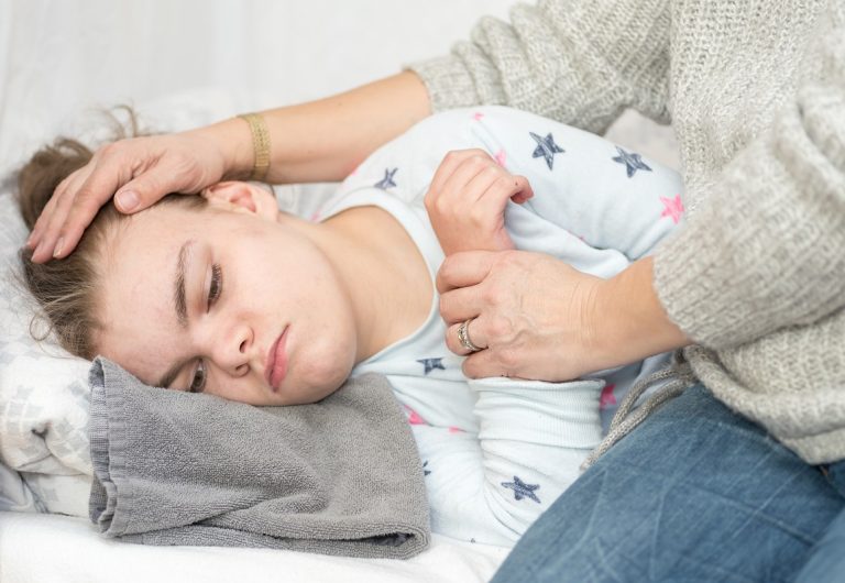 a child with epilepsy lying on the bed