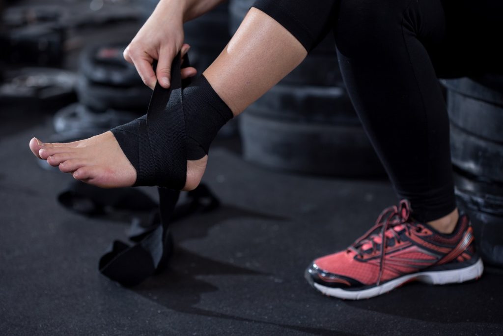 woman with ankle injury preparing to workout