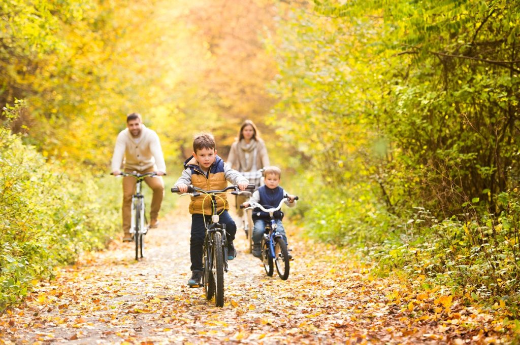 family cycling in autumn park