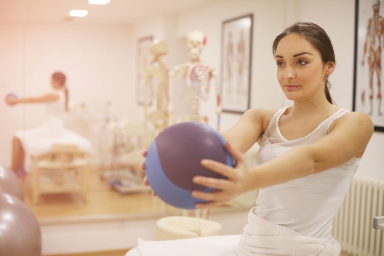 A woman exercising in a physical therapy center