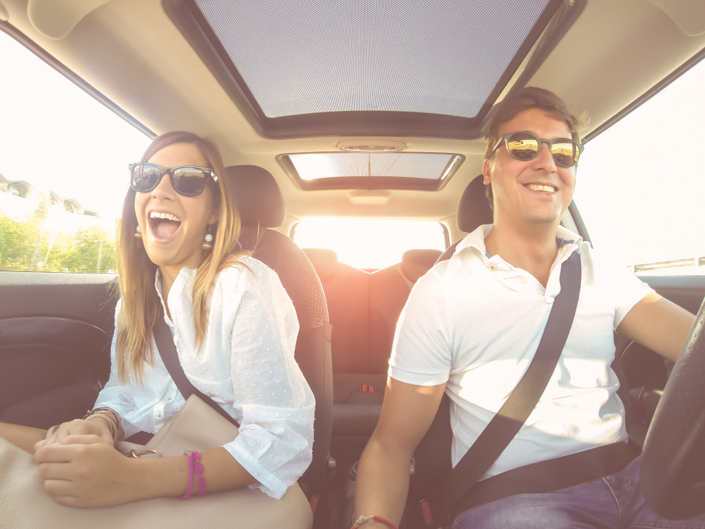 couple in the car wearing sunglasses
