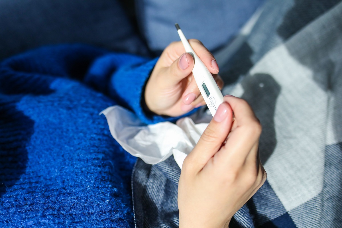 woman checking a digital thermometer